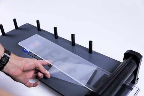 Hold the flap and feed components through the rollers